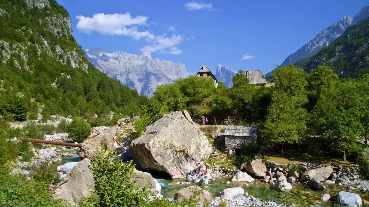 Gentle valley paths through the meadows of Theth beneath the Alps