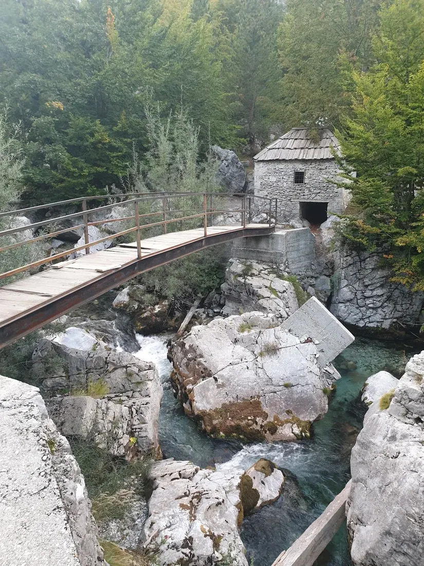 Old stone water-mill and wooden footbridge over the Valbona river at Mulliri i Vjetër